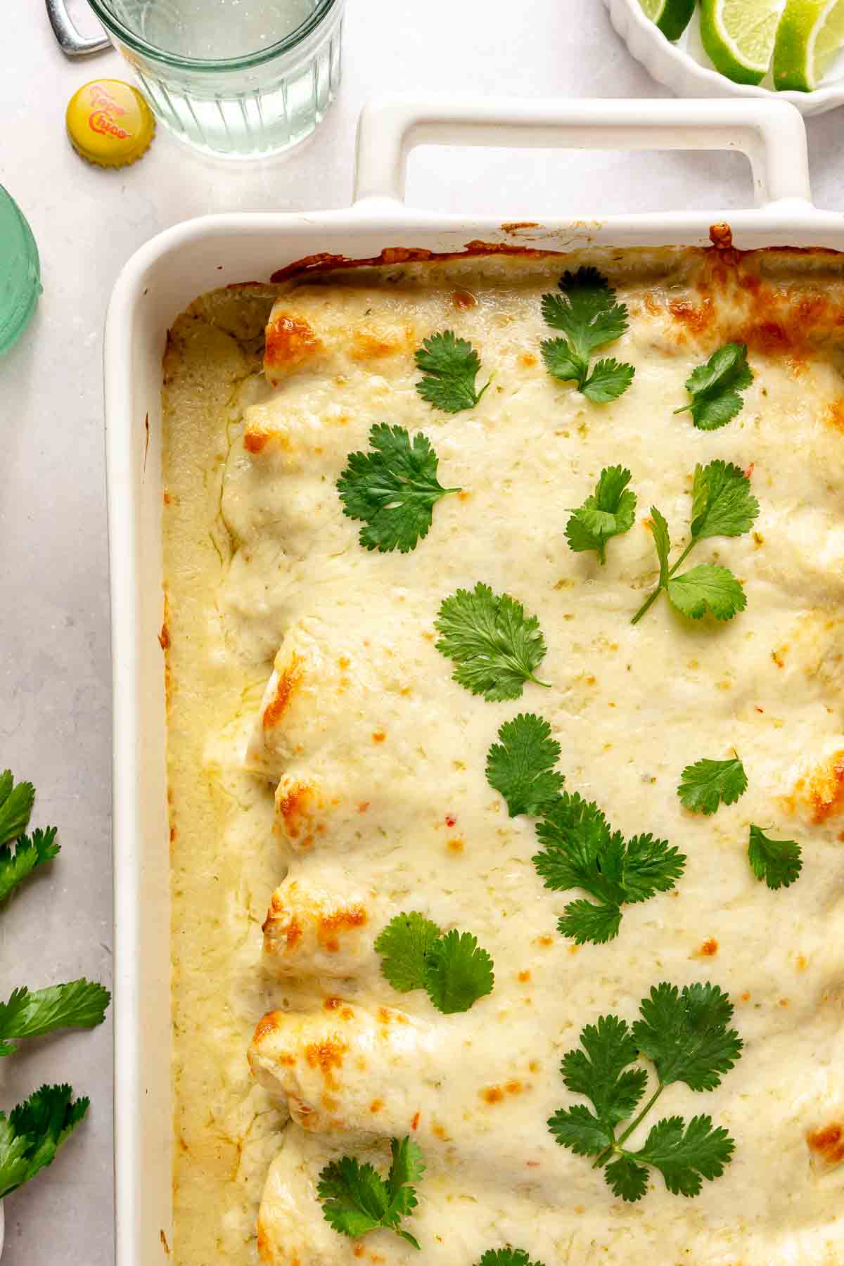 Chicken enchiladas garnished with fresh cilantro.