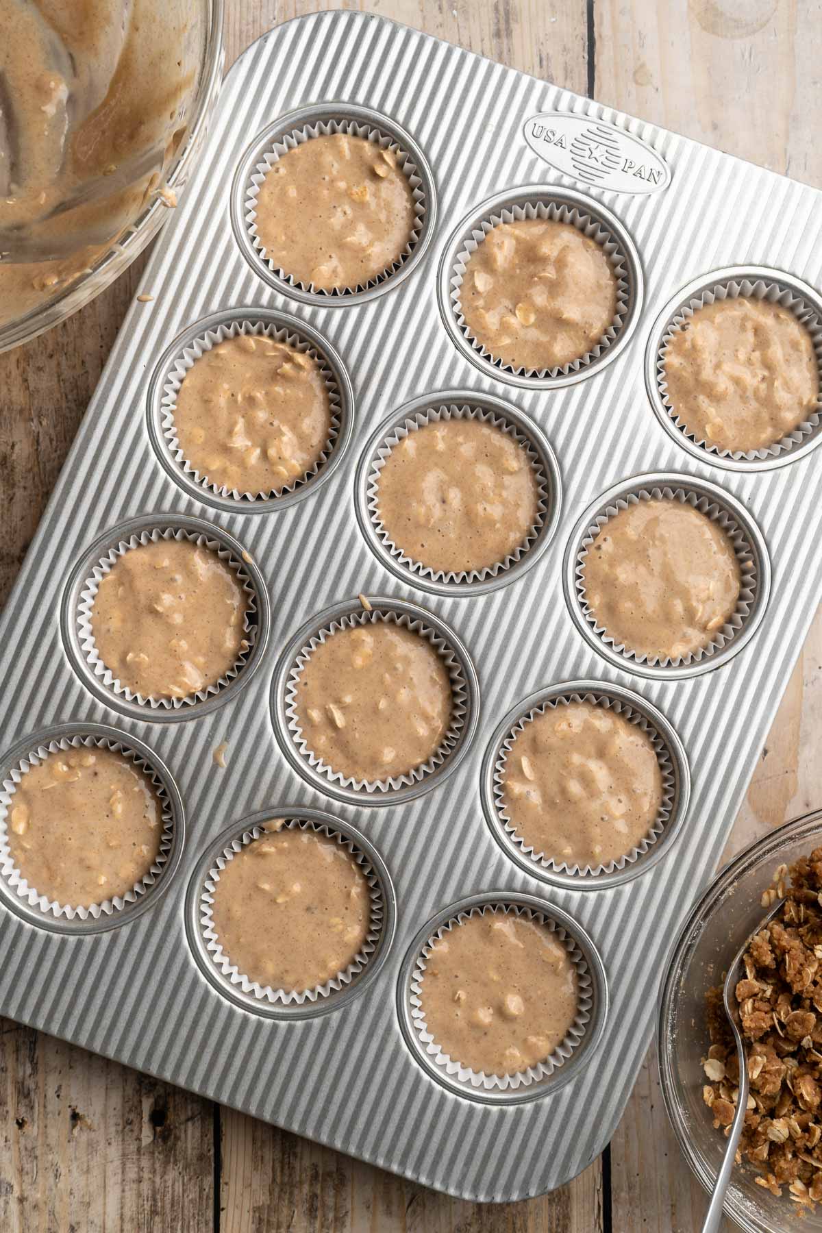 Muffin batter in a muffin pan.