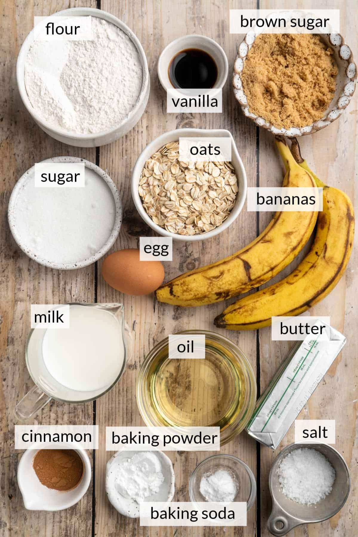 Bowl with oats, sugar, flour, milk near bananas and an egg.