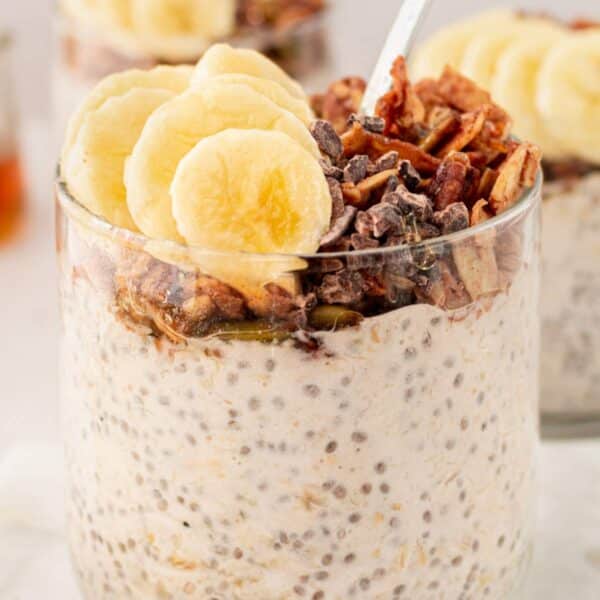 Banana overnight oats topped with granola and banana slices.