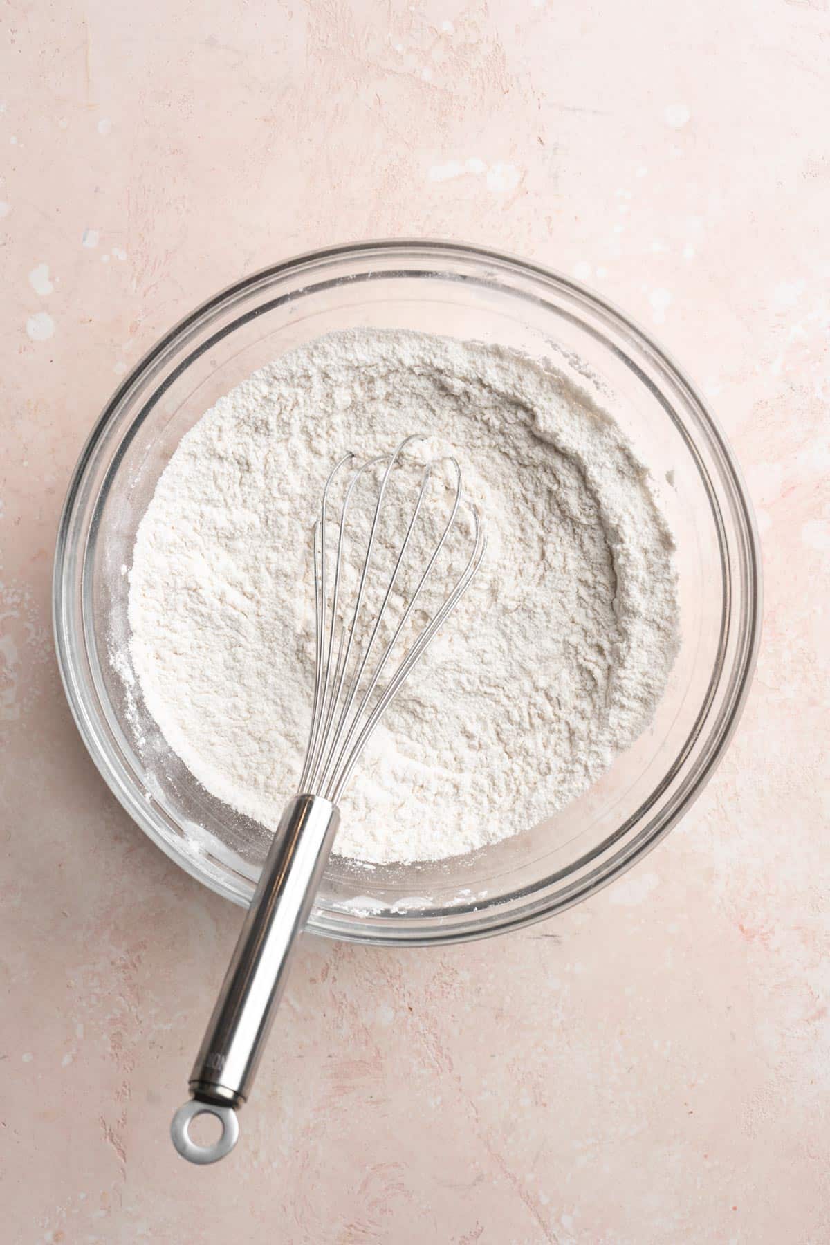 Whisking flour with baking powder and salt in a large bowl.