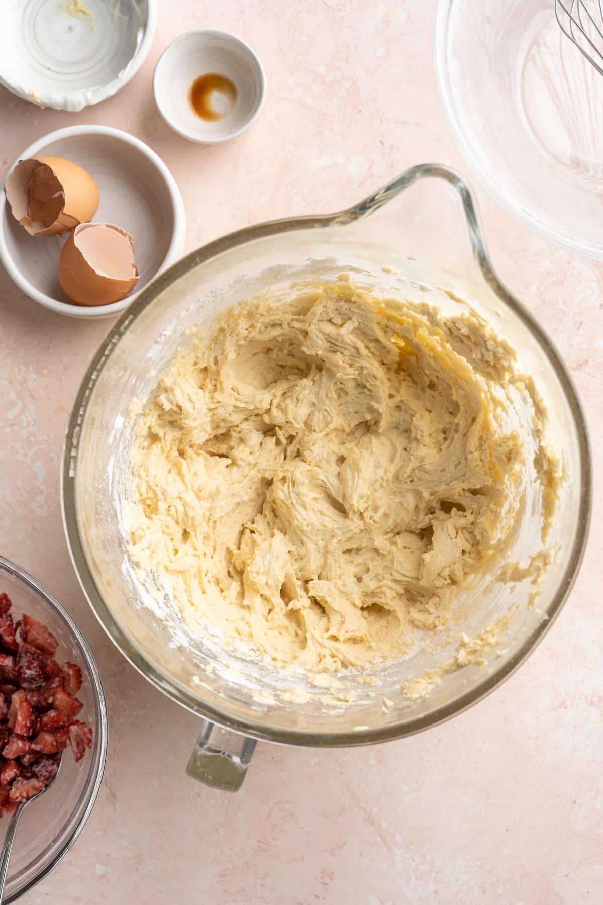 Combining flour with wet batter in a large bowl.