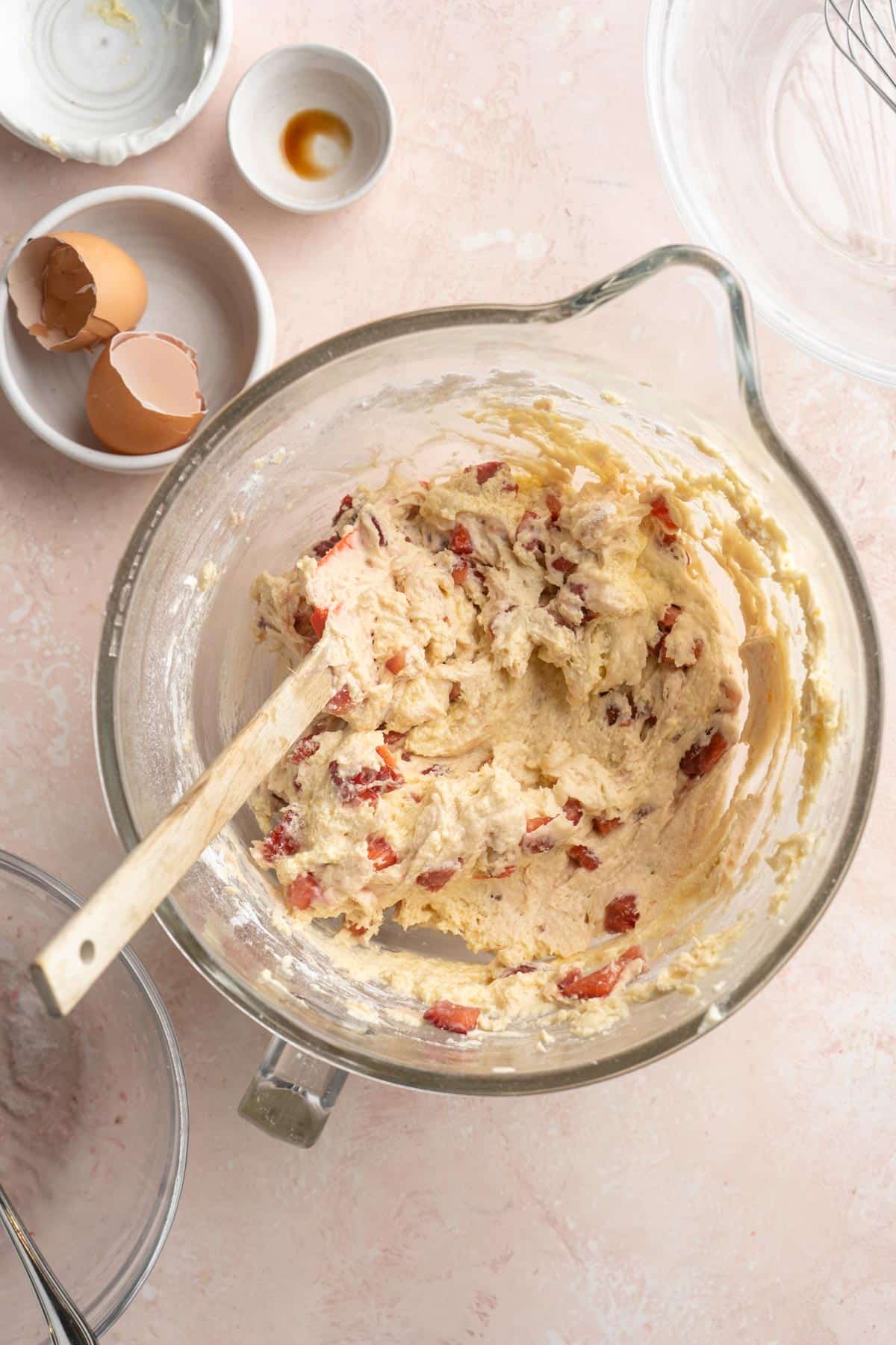 Mixing strawberries in a batter.