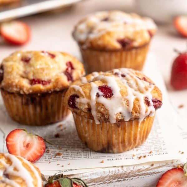 Strawberry muffins drizzled with glaze.