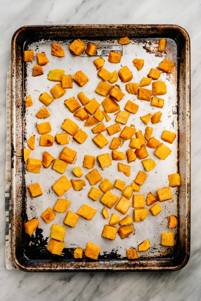 roasted cubed butternut squash on a sheet pan