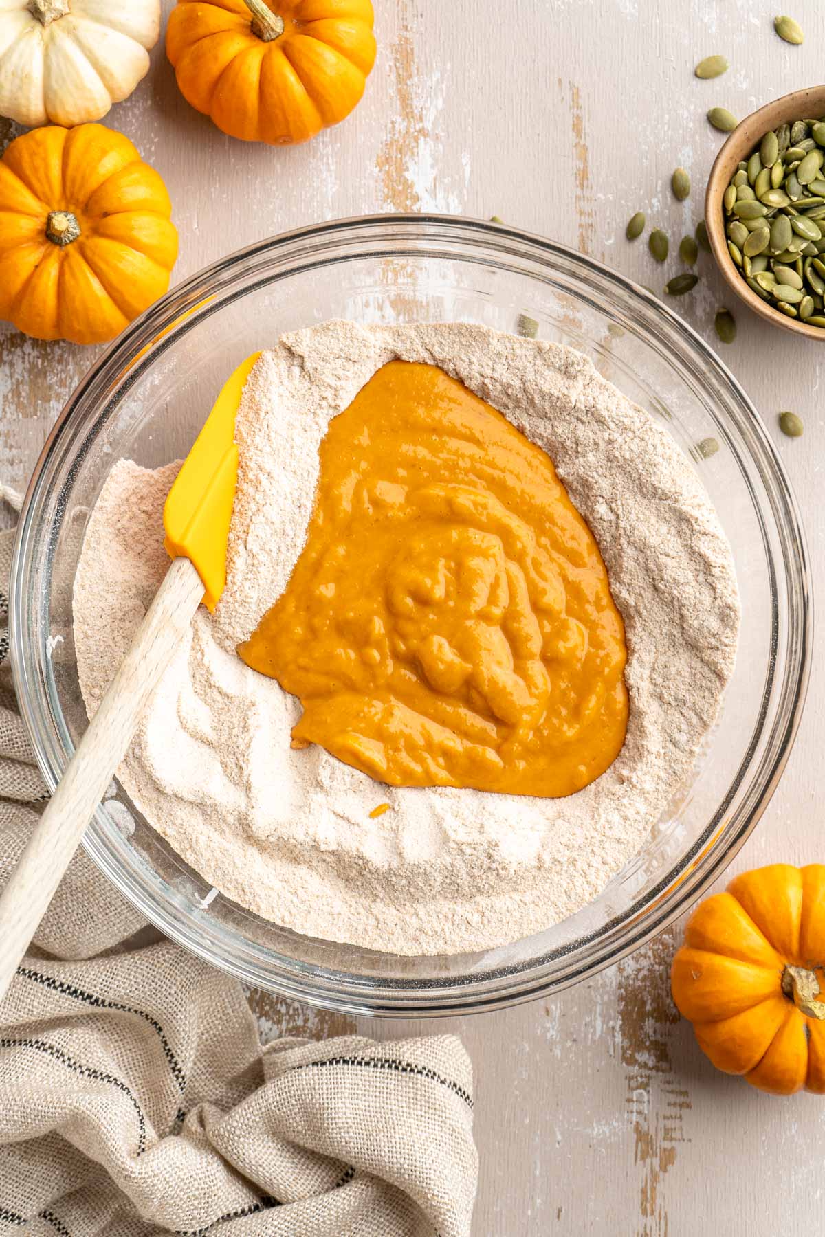 Adding wet ingredients to the center of the dry flour mixture in a large bowl.