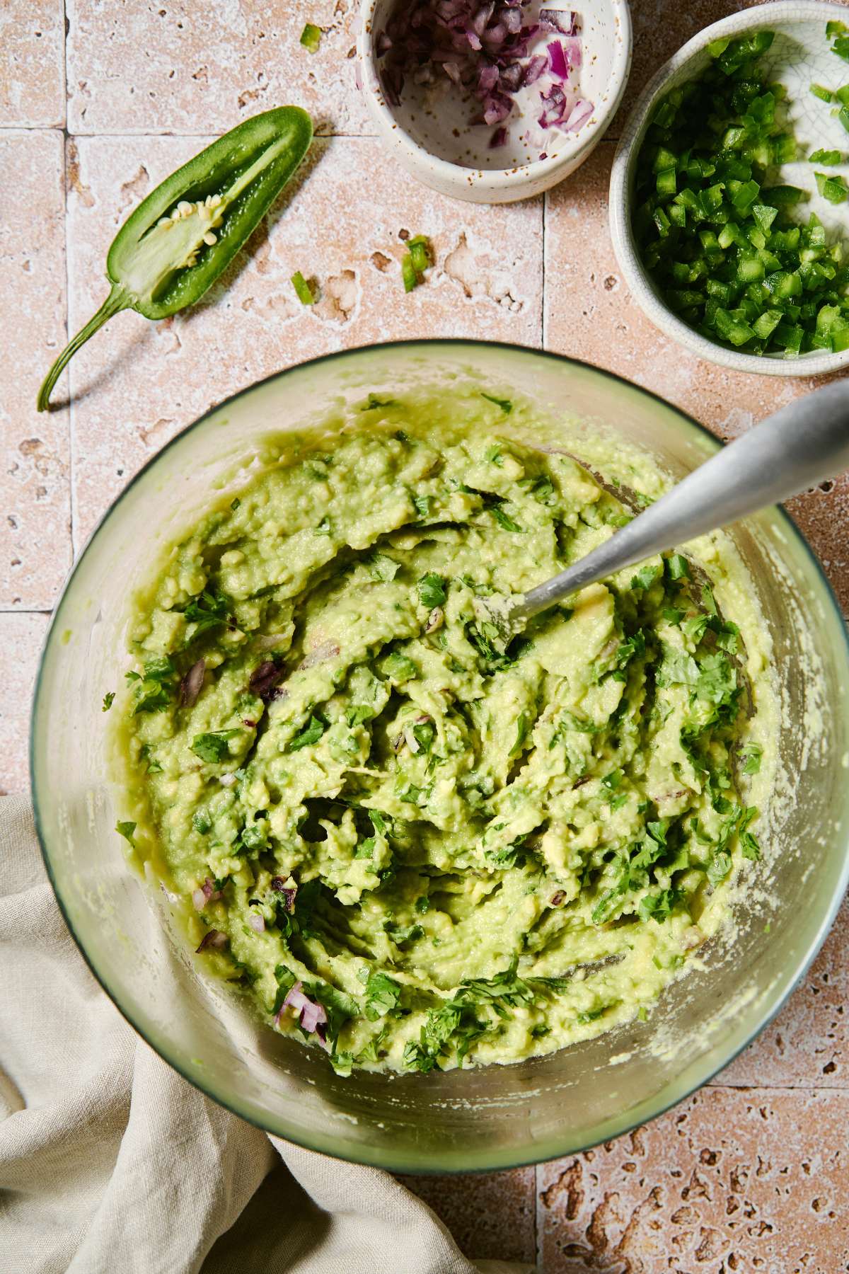 Stirring Chipotle's guacamole recipe in a large bowl.