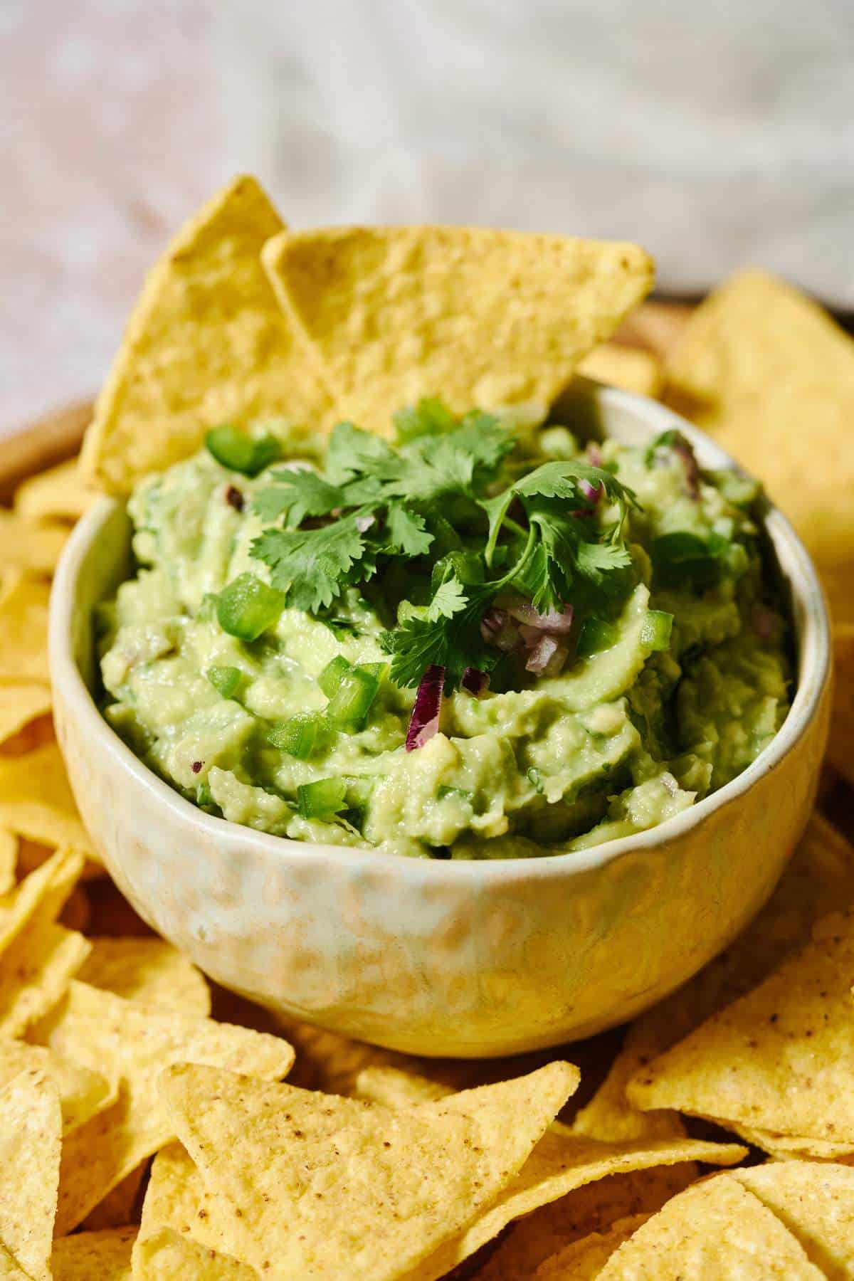 Chipotle guacamole recipe served in a small bowl garnished with fresh cilantro.