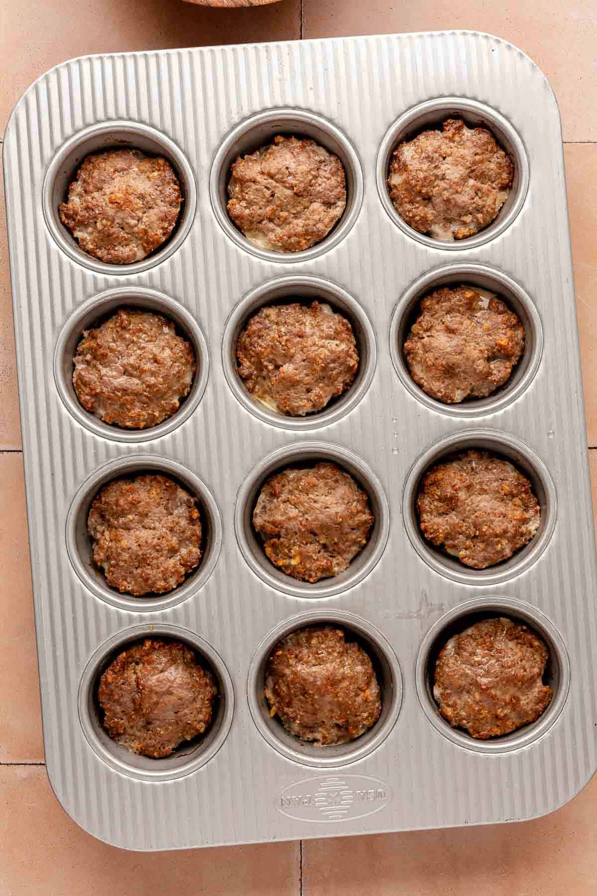 Baked mini meatloaves in a muffin pan.