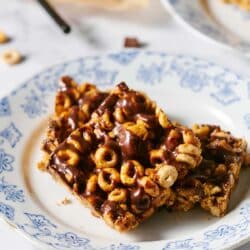 Cereal bars drizzled with chocolate on a plate.