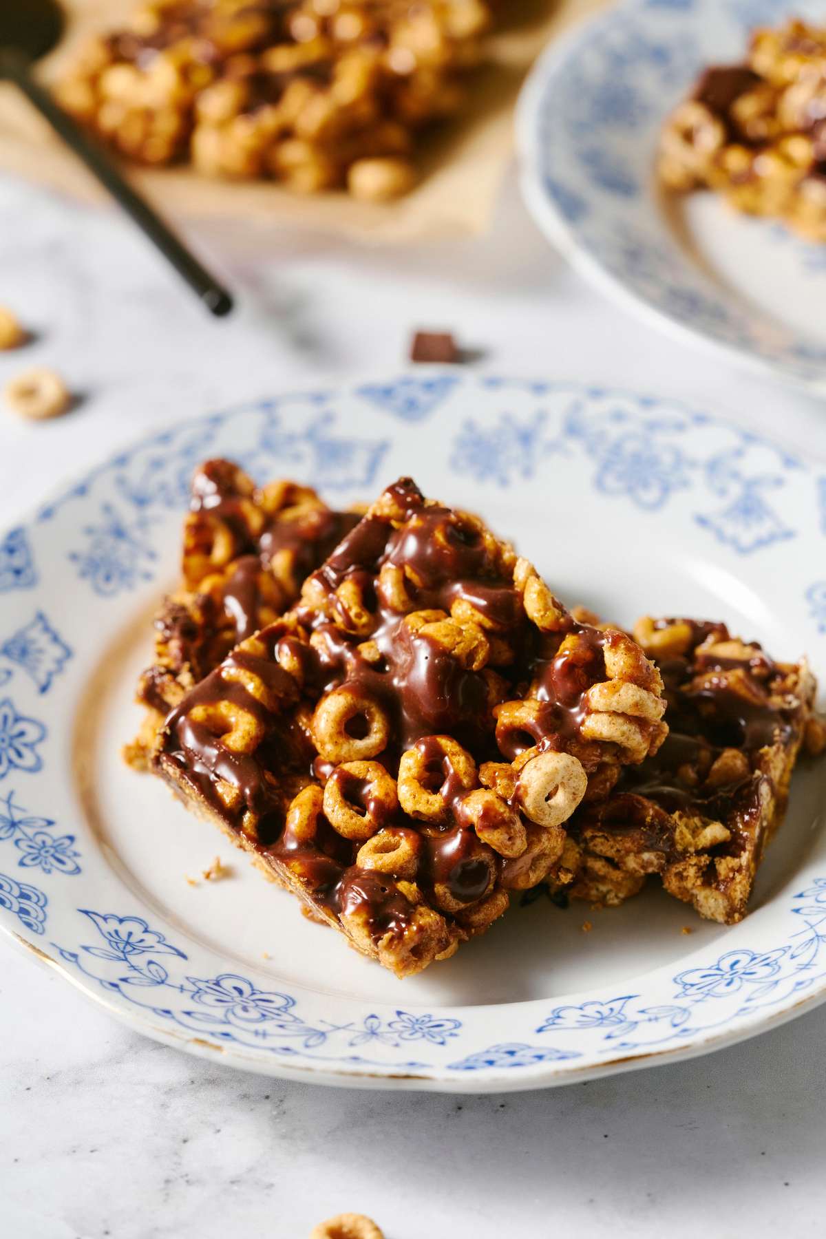 Cereal bars drizzled with chocolate on a plate.