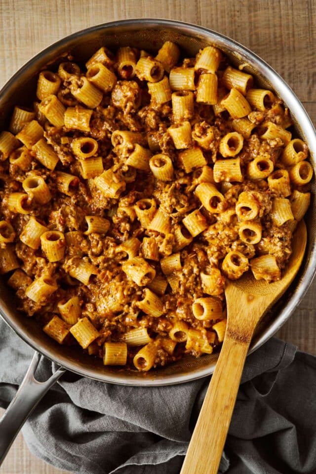 Stirring together Mexican pasta in a skillet.