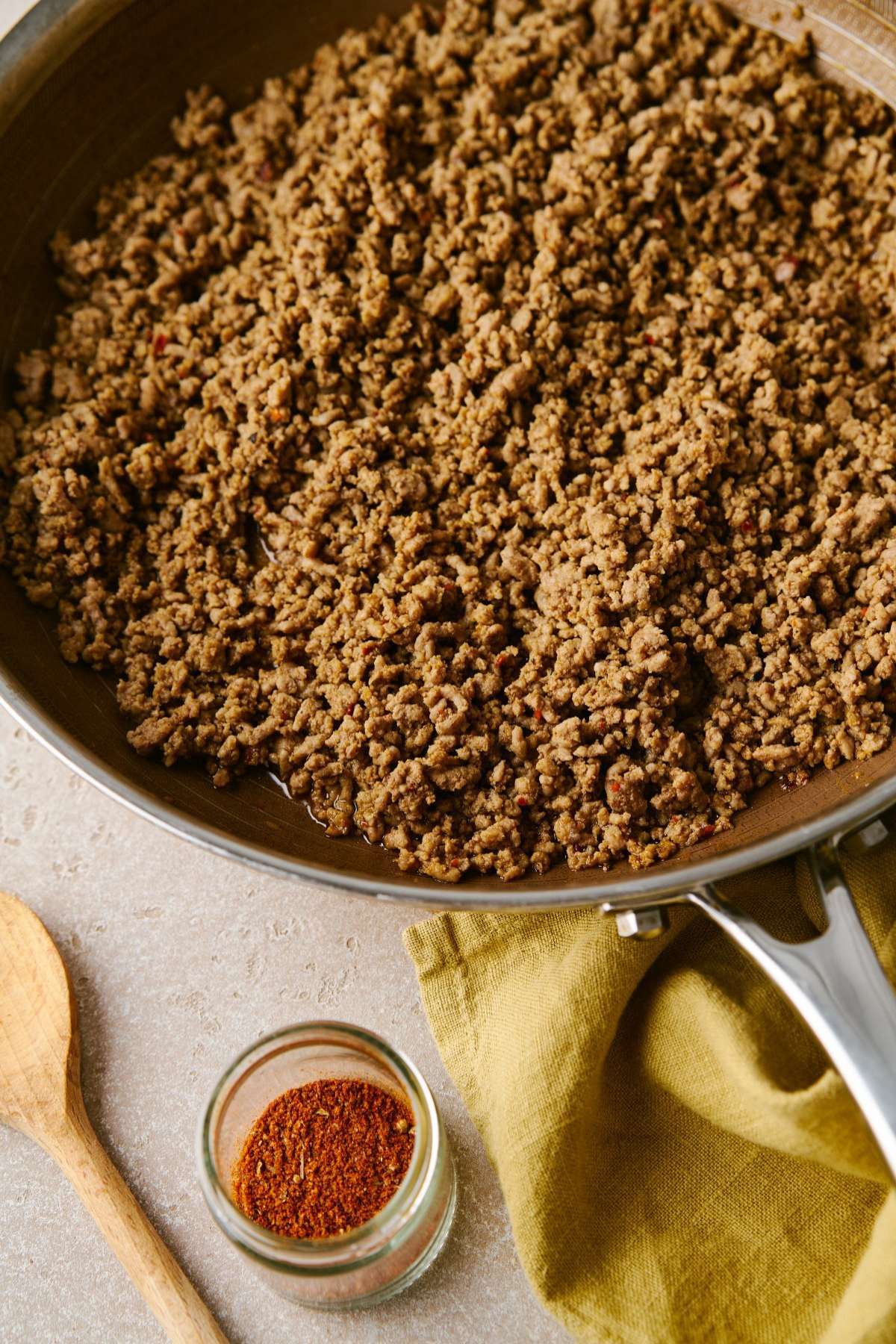 Seasoned cooked ground meat in a pan.