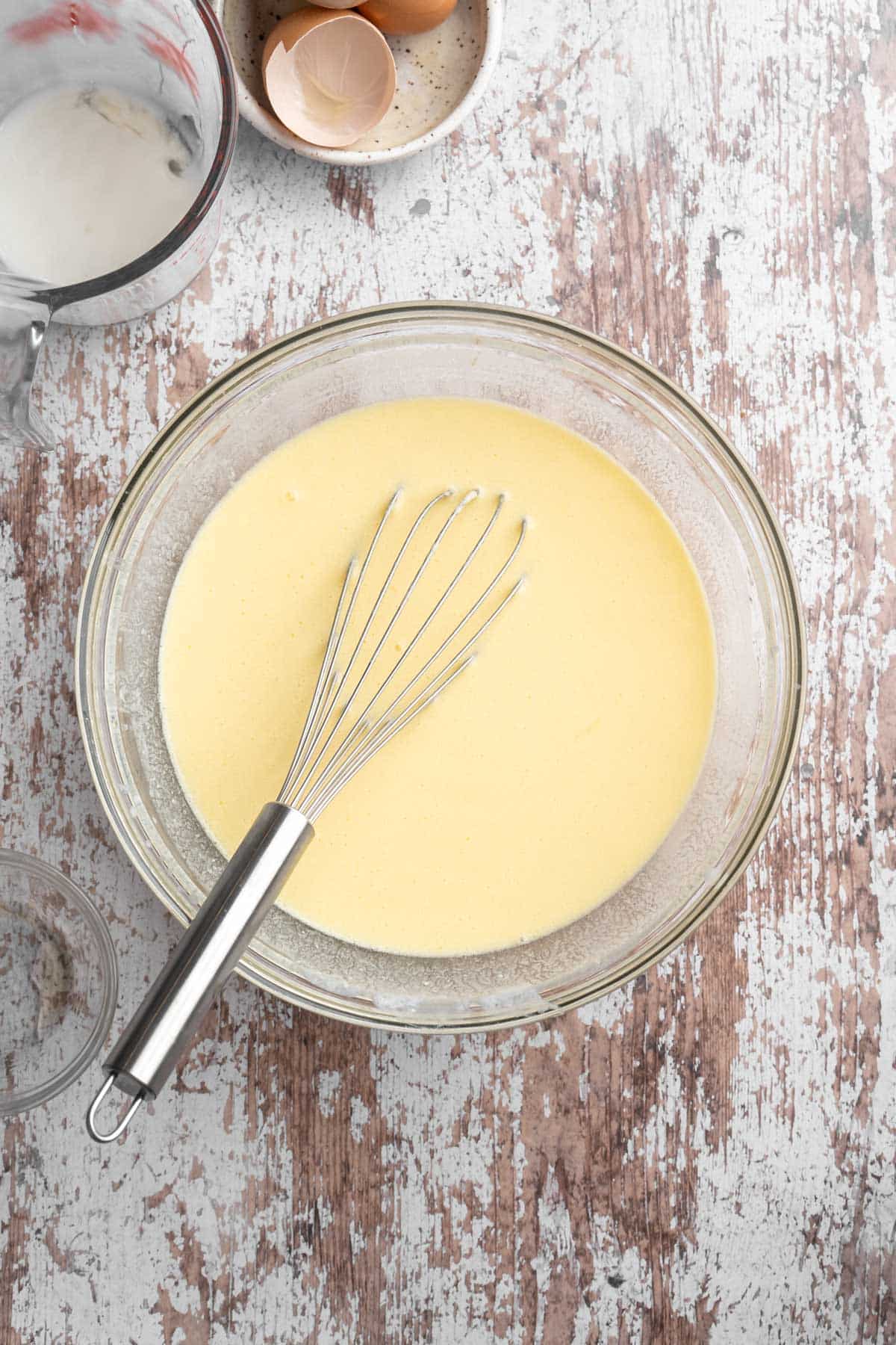 Whisking buttermilk with butter and honey in a large bowl.