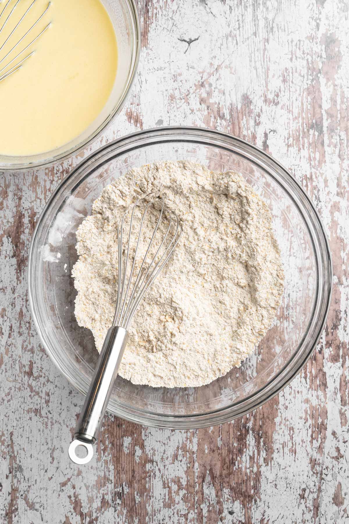 Whisking together flour with cornmeal and rolled oats.