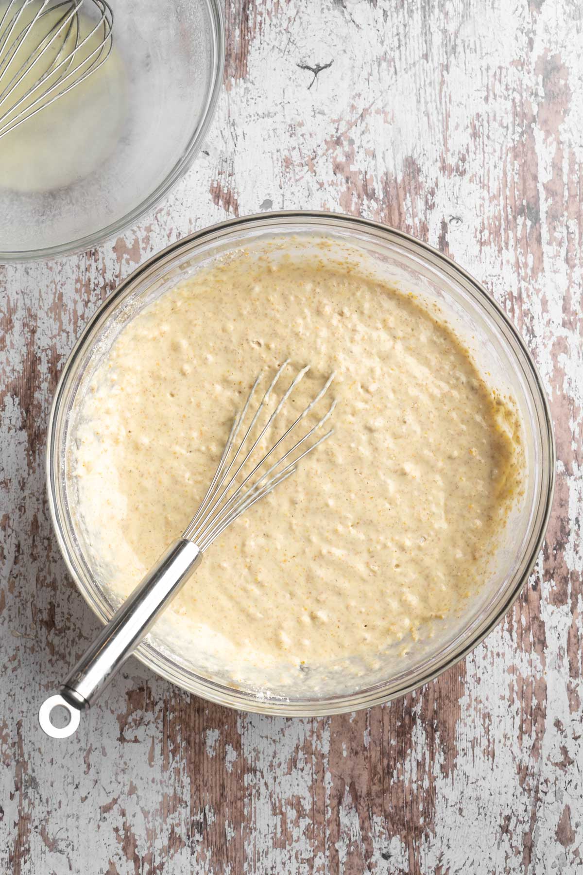 Whisking pancake batter in a large bowl.