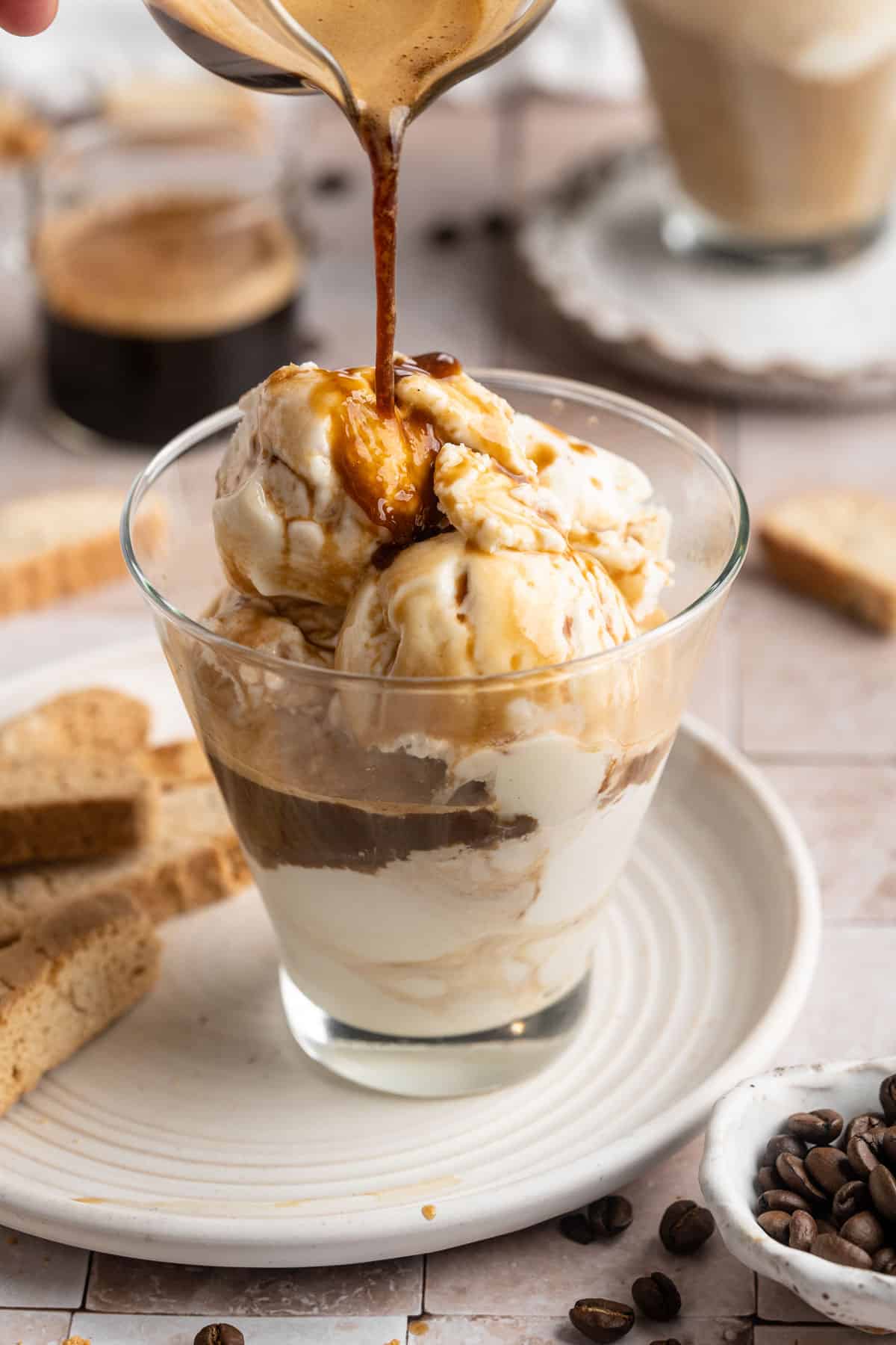 Making an affogato with ice cream and espresso.