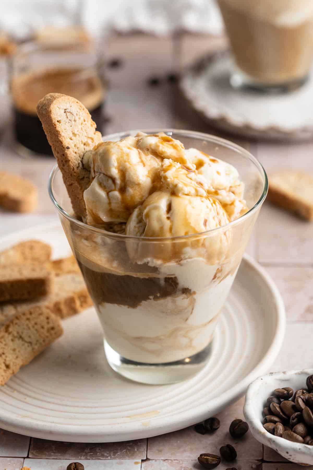 Salted caramel affogato served with a biscotti.