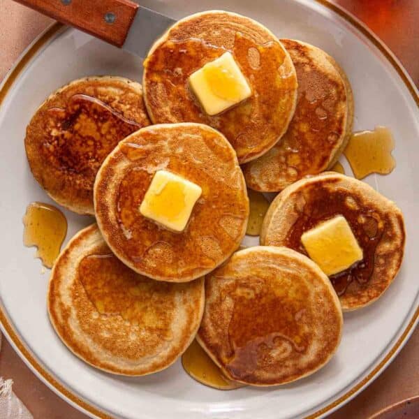 Plate with protein pancakes topped with syrup and butter.