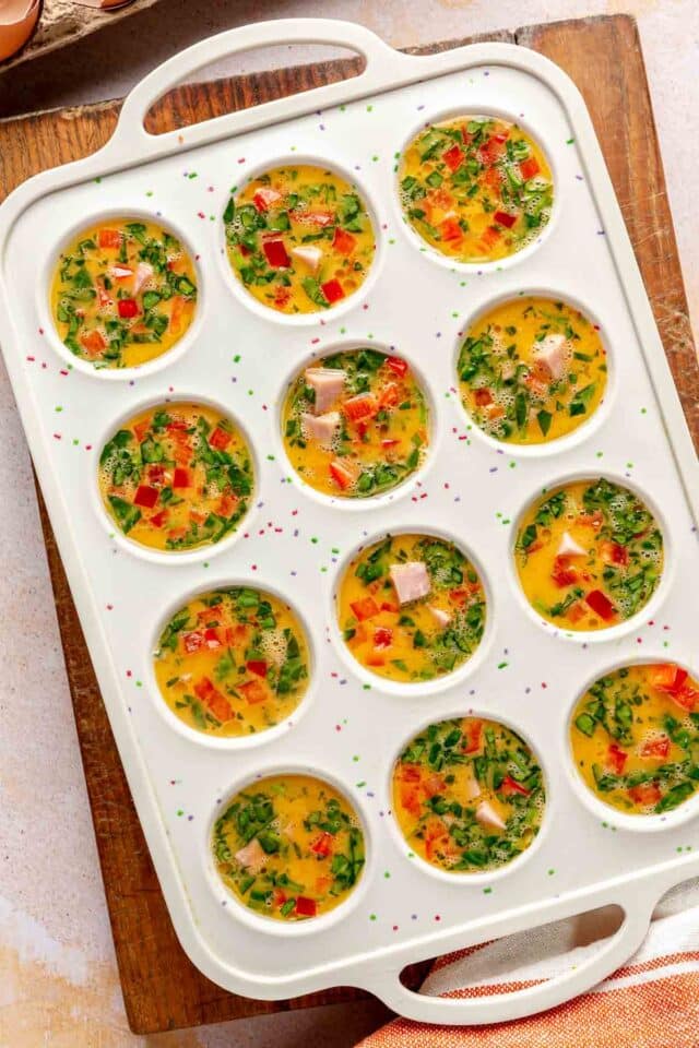 Egg mixture in a muffin pan before baking.