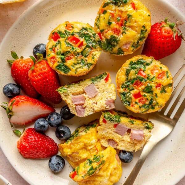 Egg muffins on a plate with fresh berries.