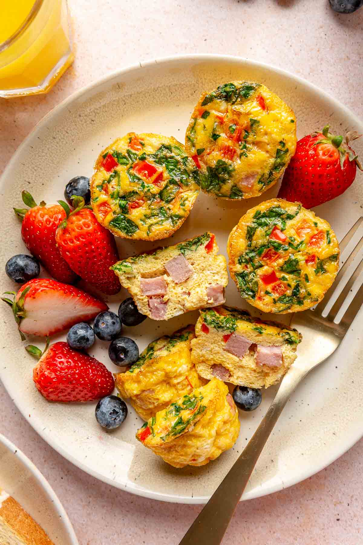 Egg muffins on a plate with fresh berries.