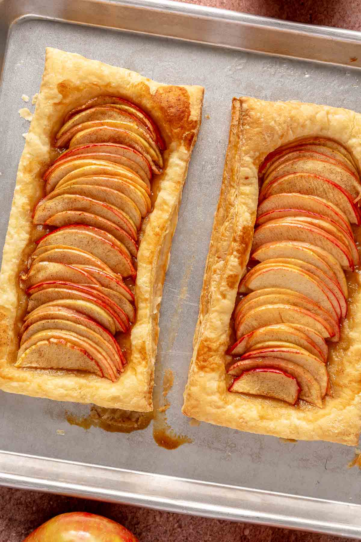 Baked apple tarts on a sheet pan.