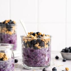 Blueberry overnight oats topped with granola and fresh blueberries.