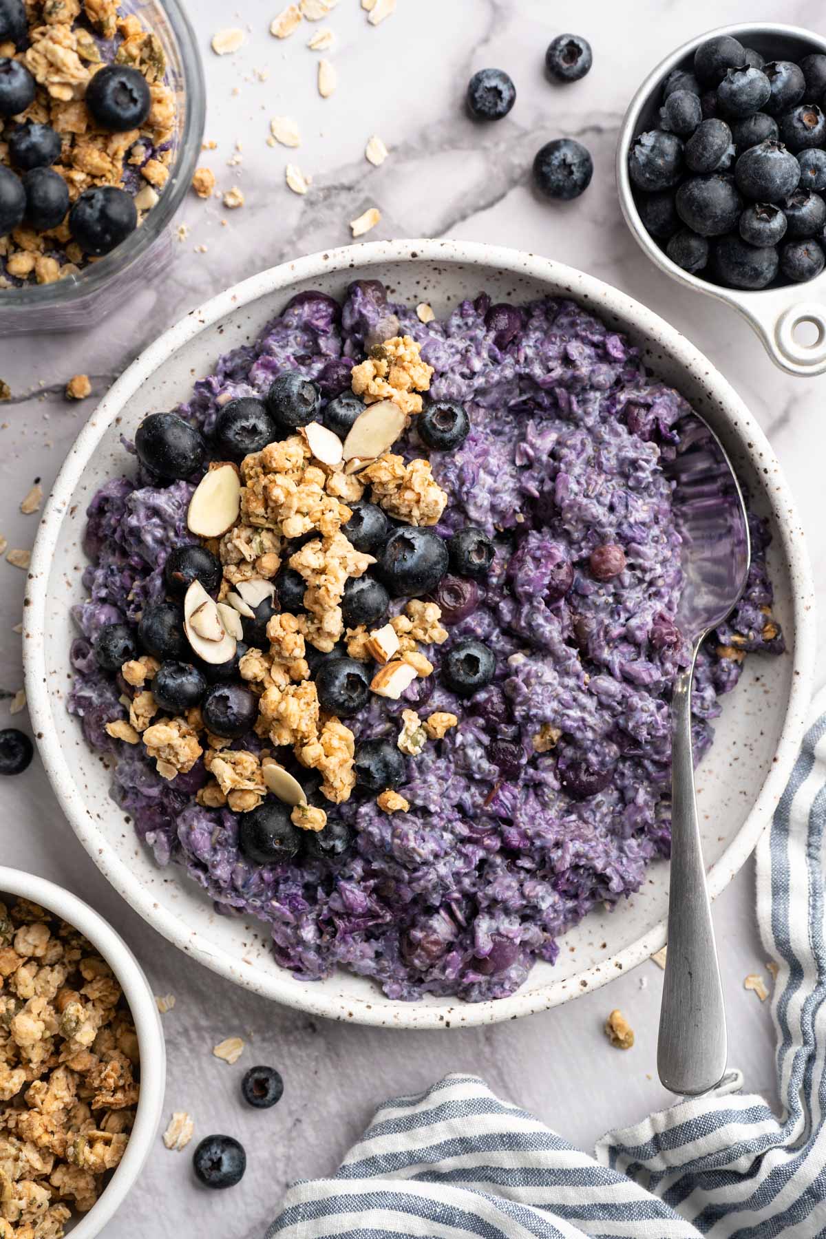 Blueberry overnight oats in a bowl with a spoon.