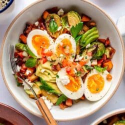 Breakfast bowl with a hard boiled egg, avocado and sweet potato hash.