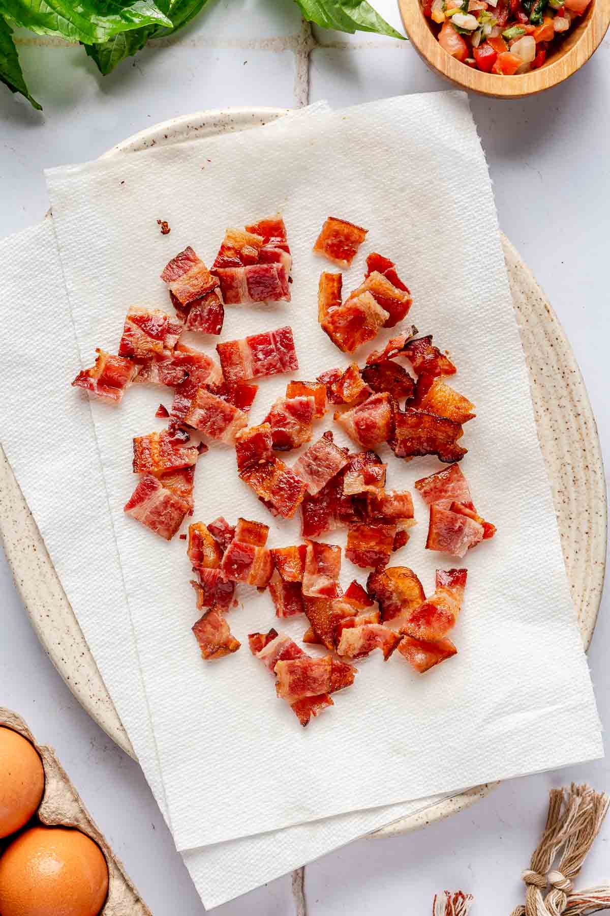 Crumbled bacon on a paper towel.