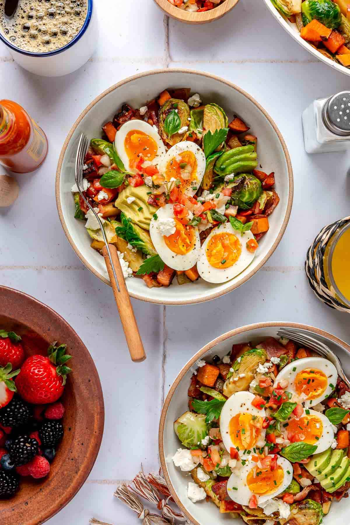 Breakfast bowls with sweet potato hash and soft-boiled eggs.