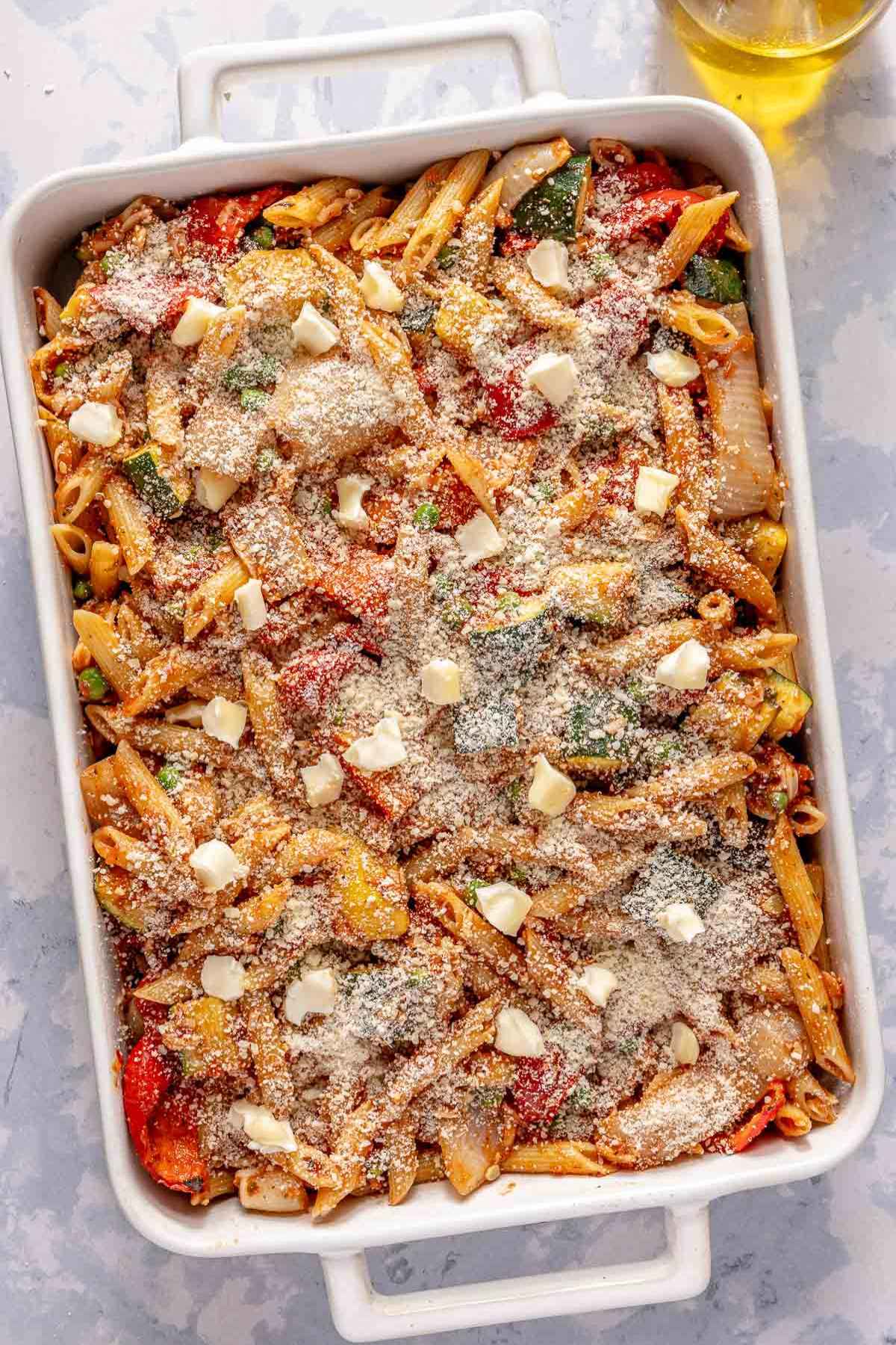 Pasta and veggies in a casserole dish before baking.