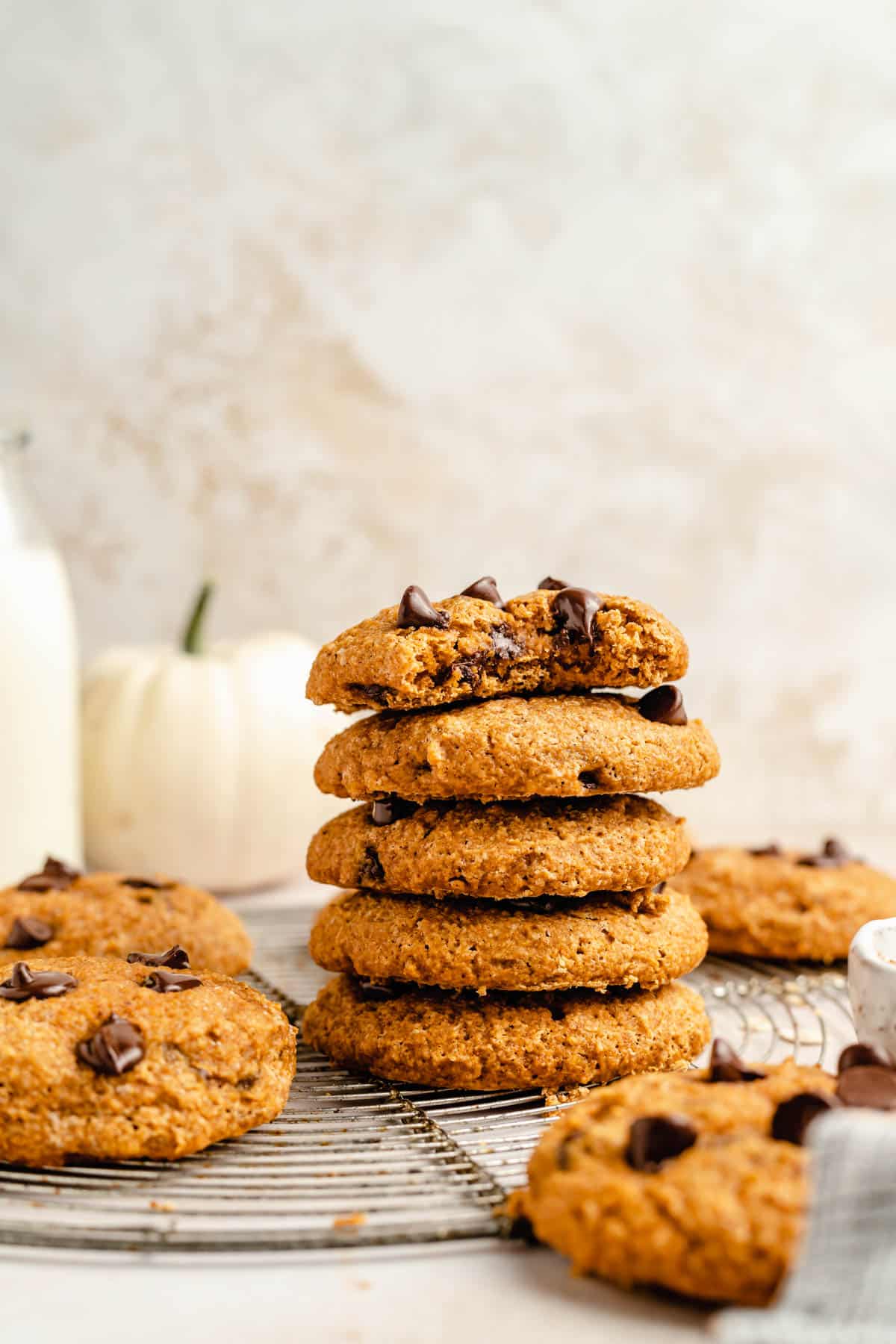 healthy pumpkin cookies stacked on a wire cooling rack