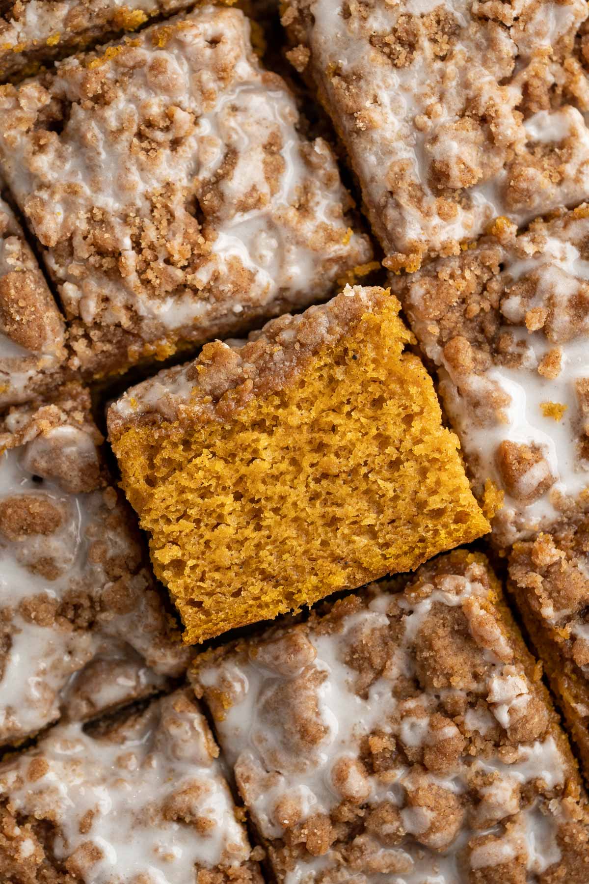 Pumpkin coffee cake topped with icing.