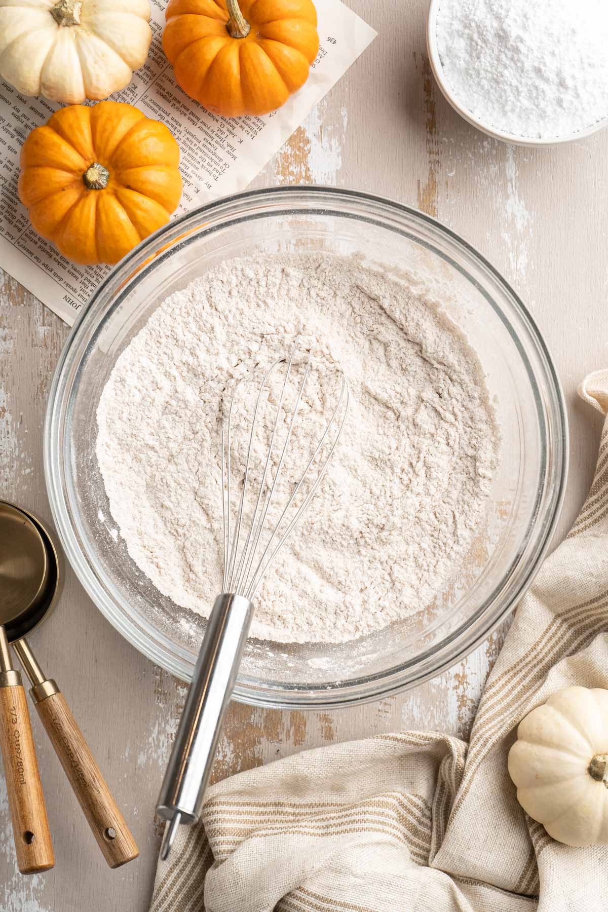 Whisking flour with baking powder, baking soda and salt in a large bowl.