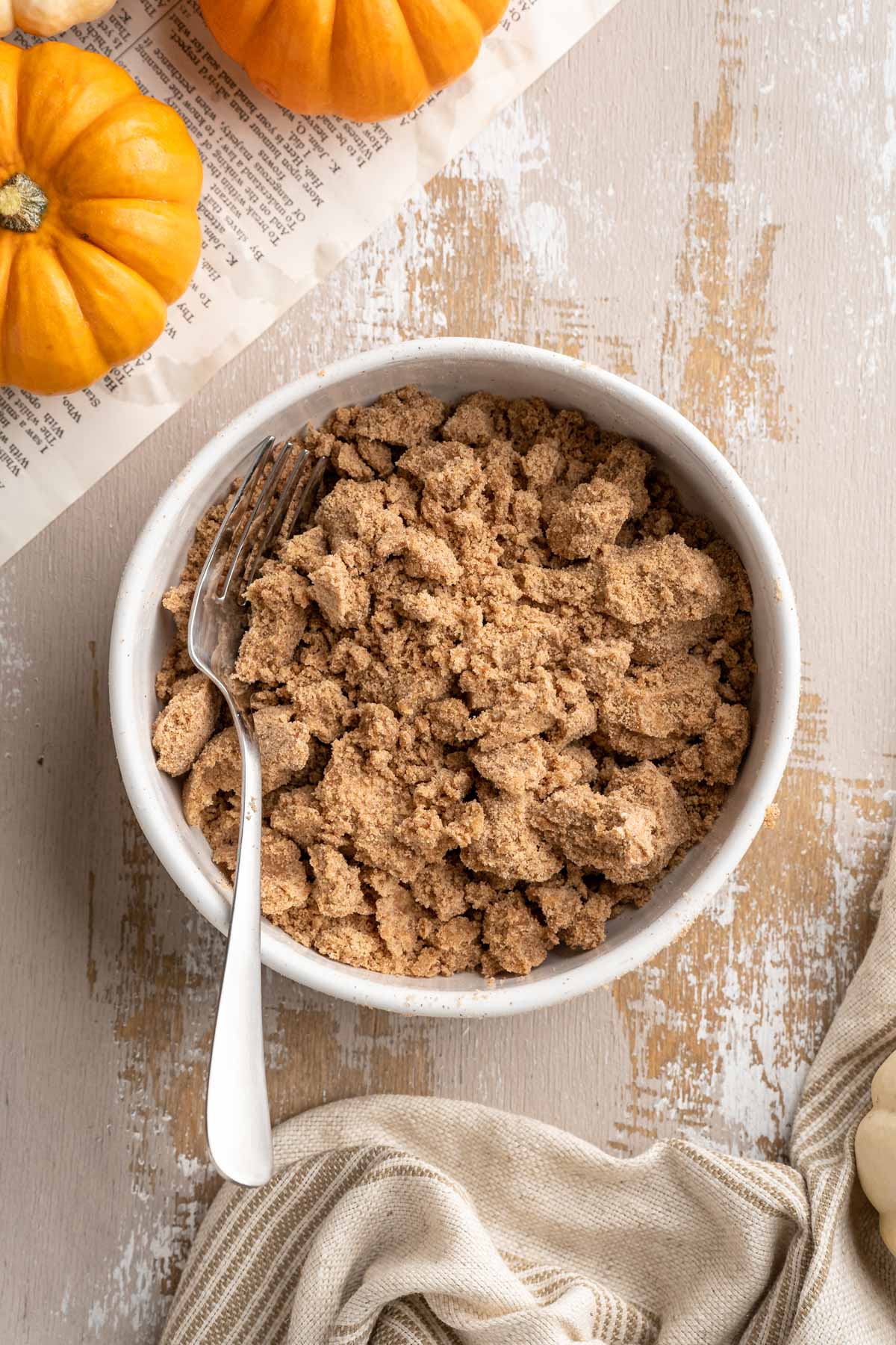 Mixing together flour, brown sugar, butter and cinnamon in a small bowl.