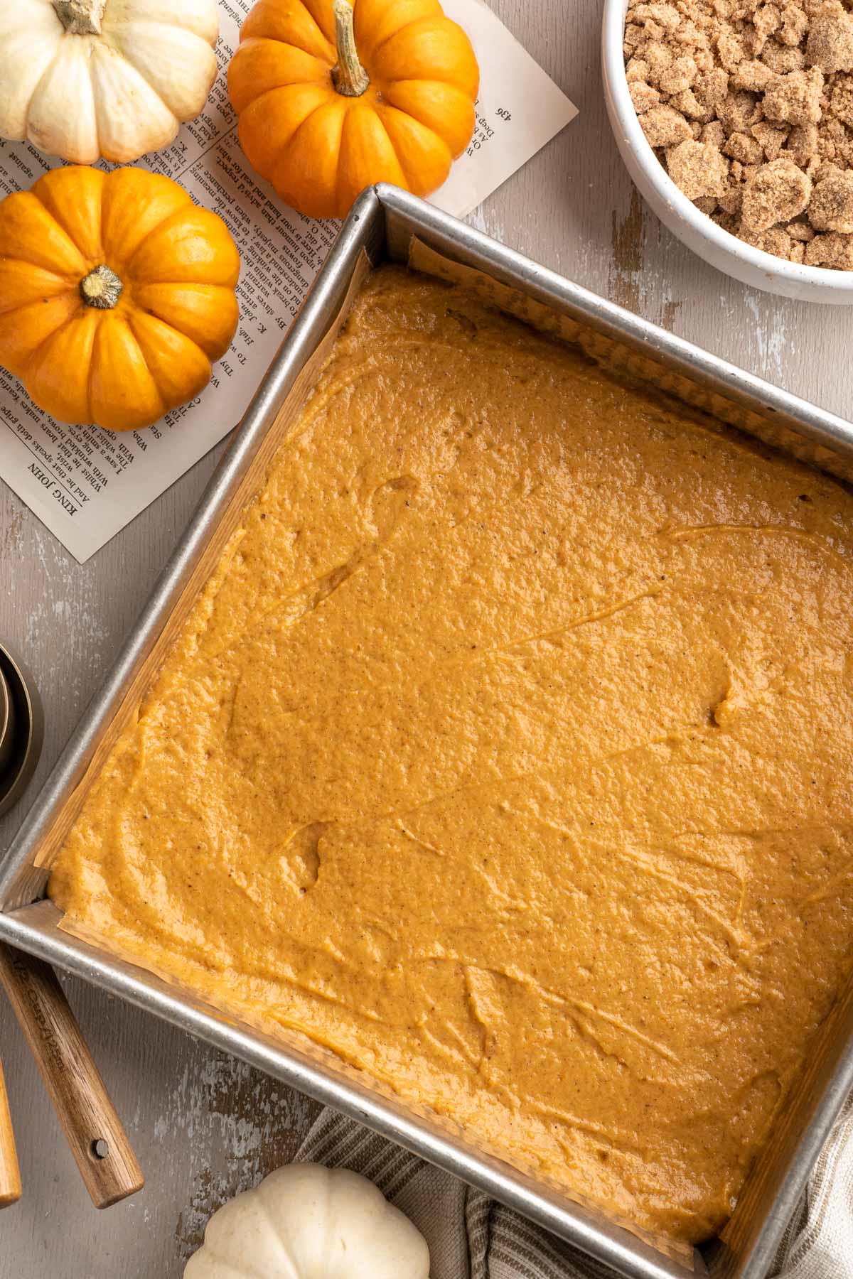 Pumpkin coffee cake batter in a square pan.