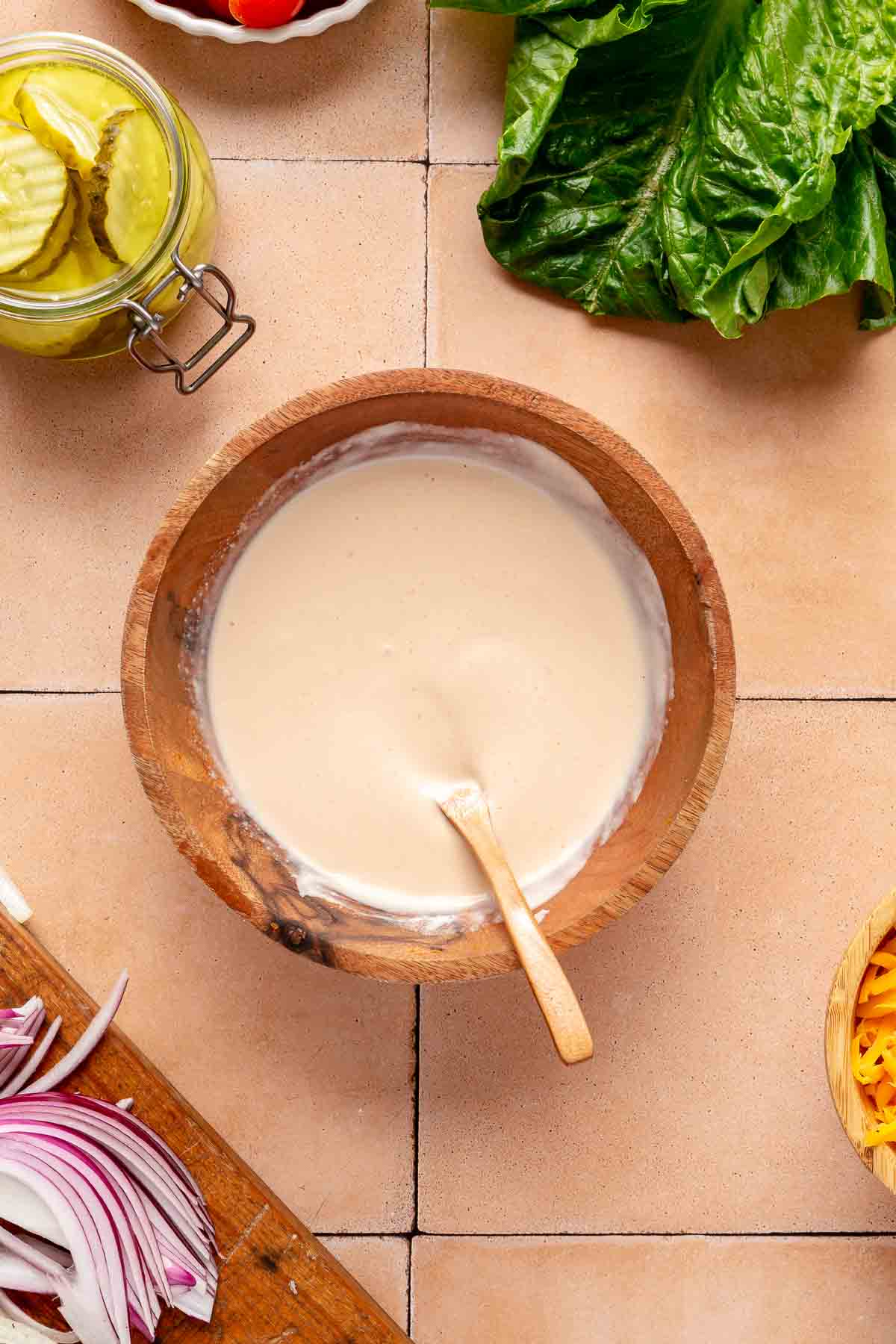 Stirring burger sauce together in a small bowl.