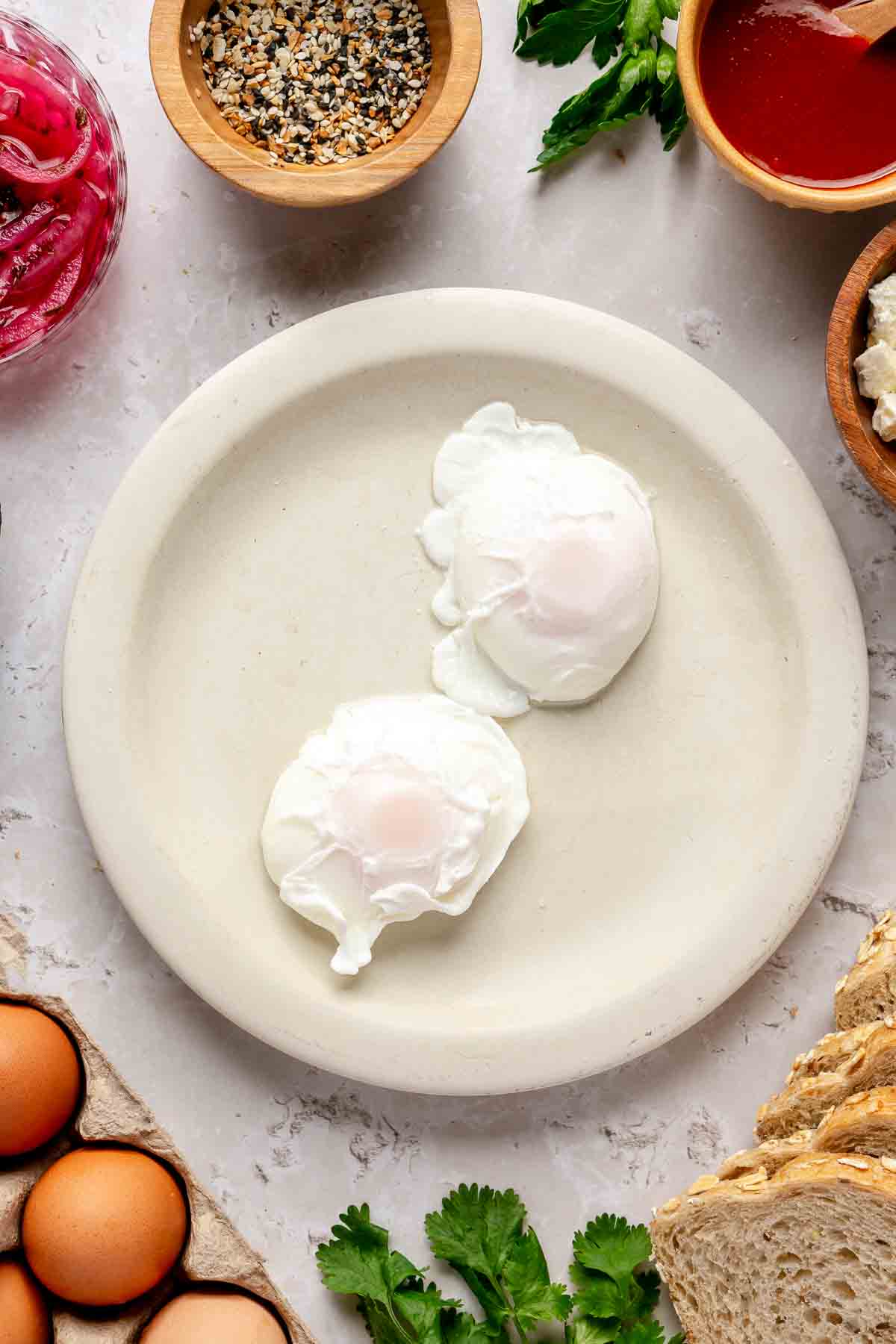 Two poached eggs on a white plate.