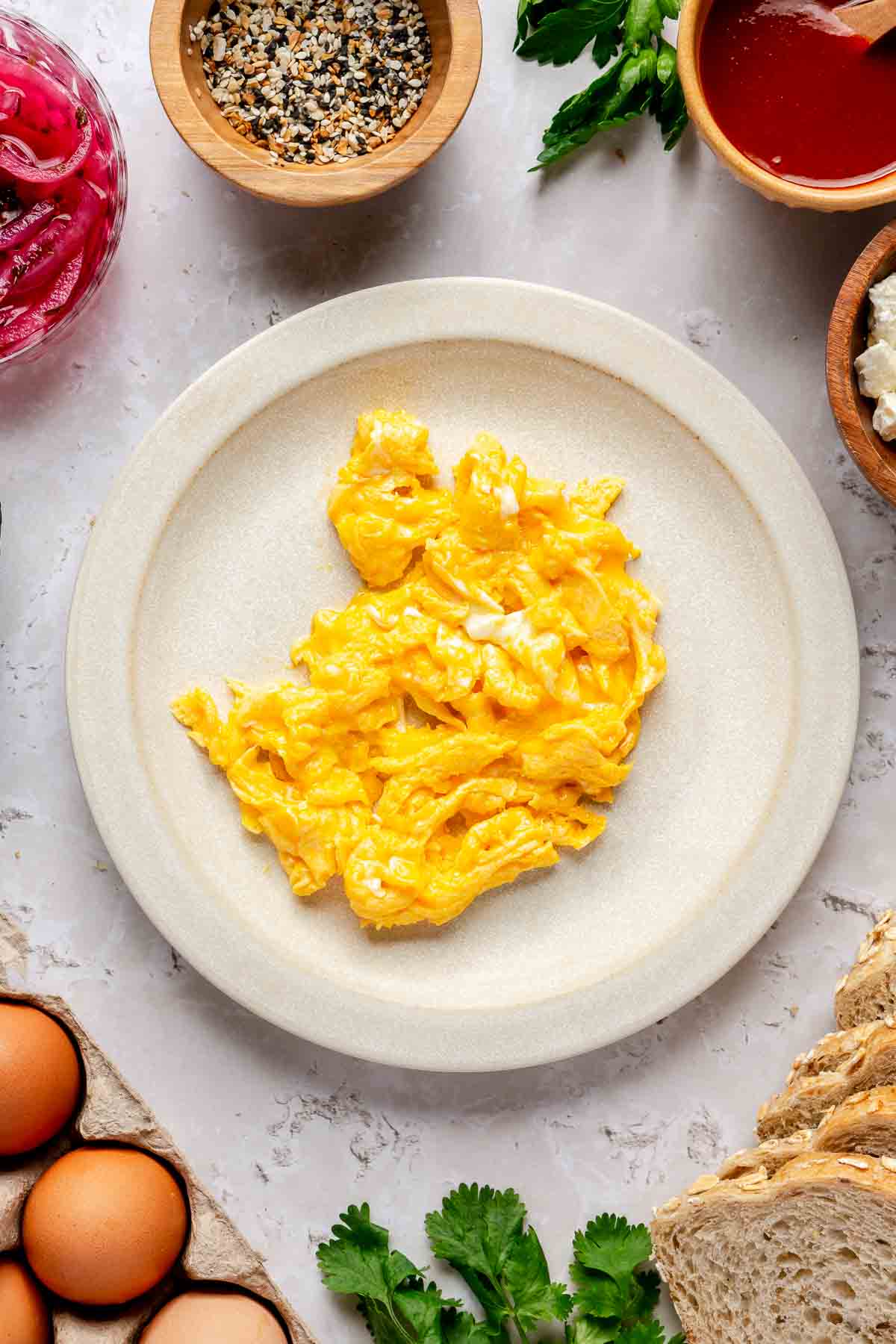 Scrambled eggs on a white plate.