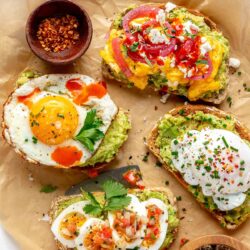 Avocado toast with egg served on a parchment lined tray.