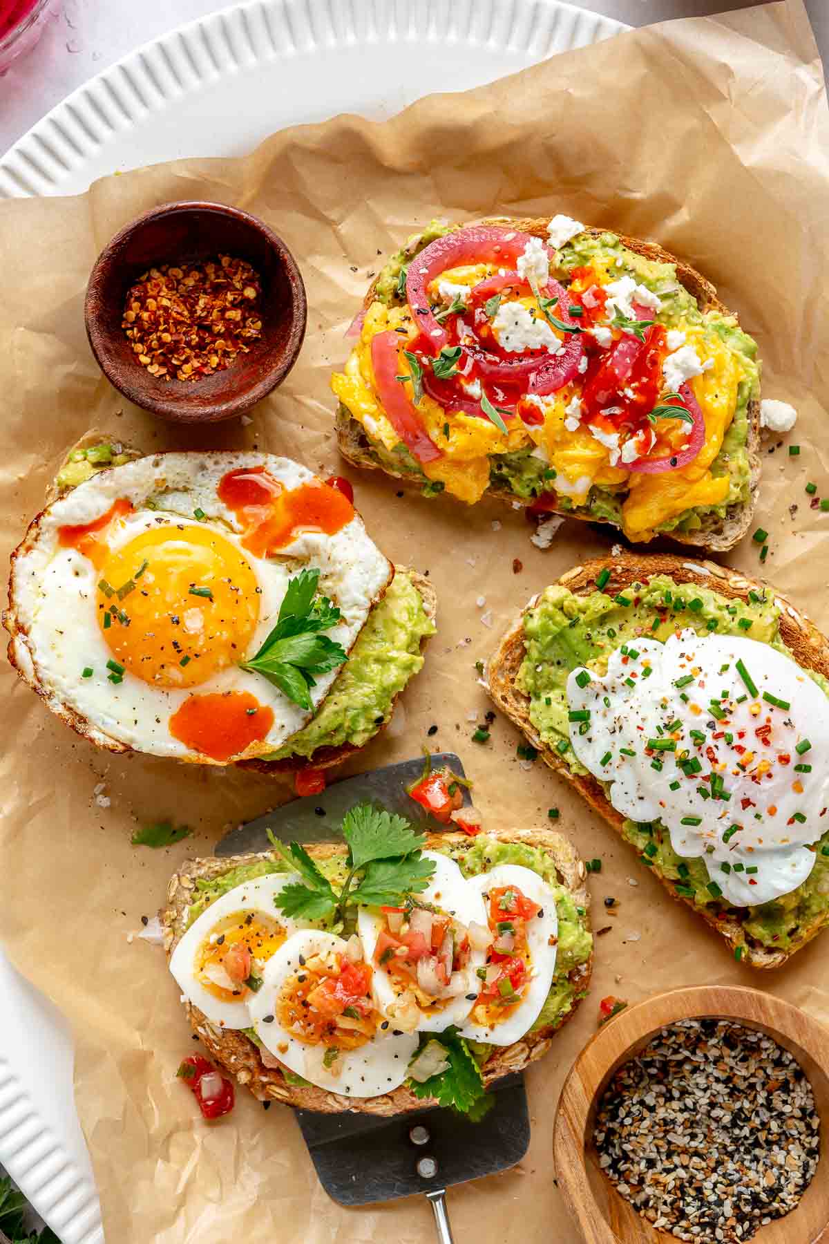 Avocado toast with egg served on a parchment lined tray.