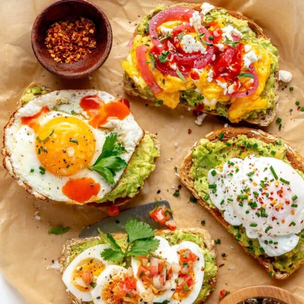 Avocado toast with egg served on a parchment lined tray.