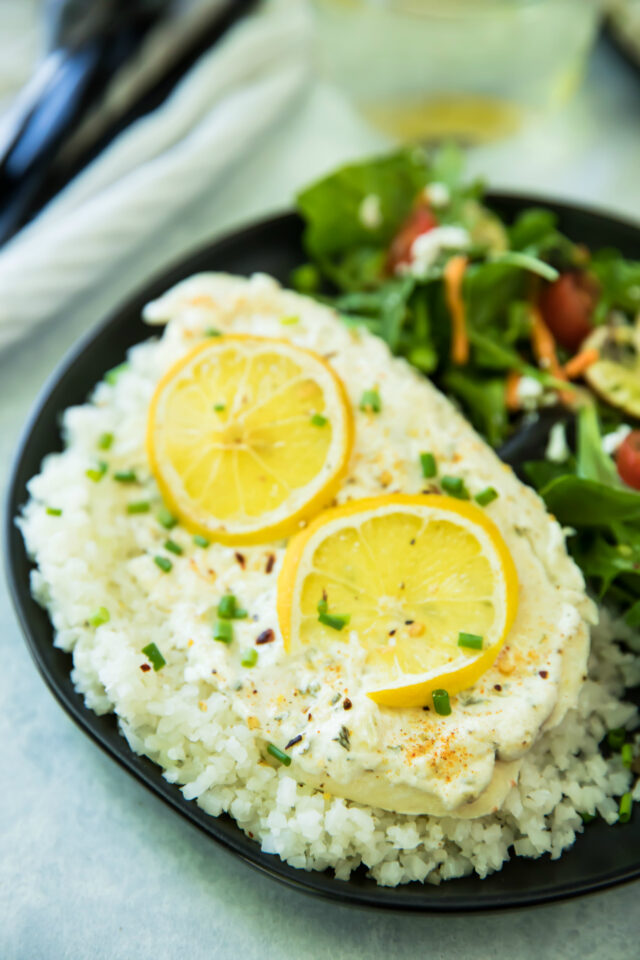 Garlic Parmesan Tilapia Over Cauliflower Rice is ready in less than 20 minutes! The tilapia cooks up light and flakey, and pairs wonderfully with cauliflower rice. It's one of my favorite ways to enjoy fish, and is so good, that even non-seafood lovers will be won over by this dish!