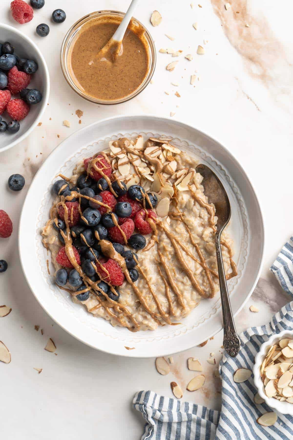 Oatmeal topped with berries, chopped almonds and almond butter.