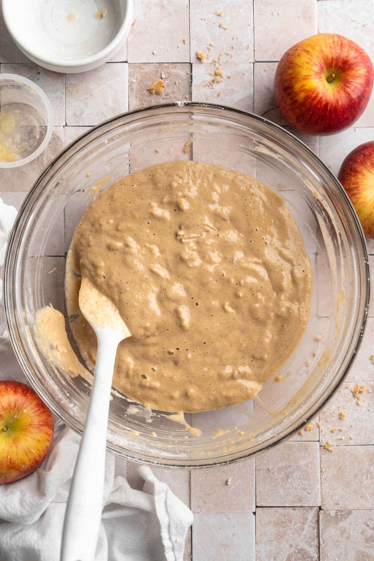 Stirring together apple muffin batter in a large bowl.