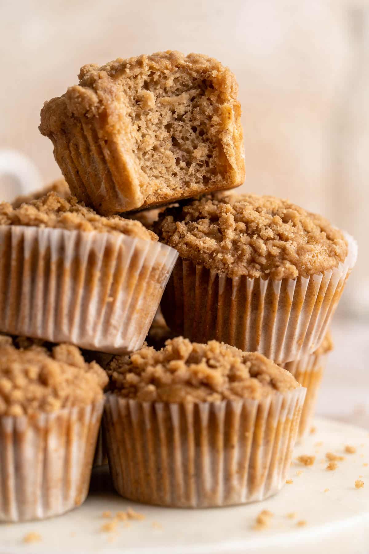 Apple muffins stacked with a bite taken out of one.