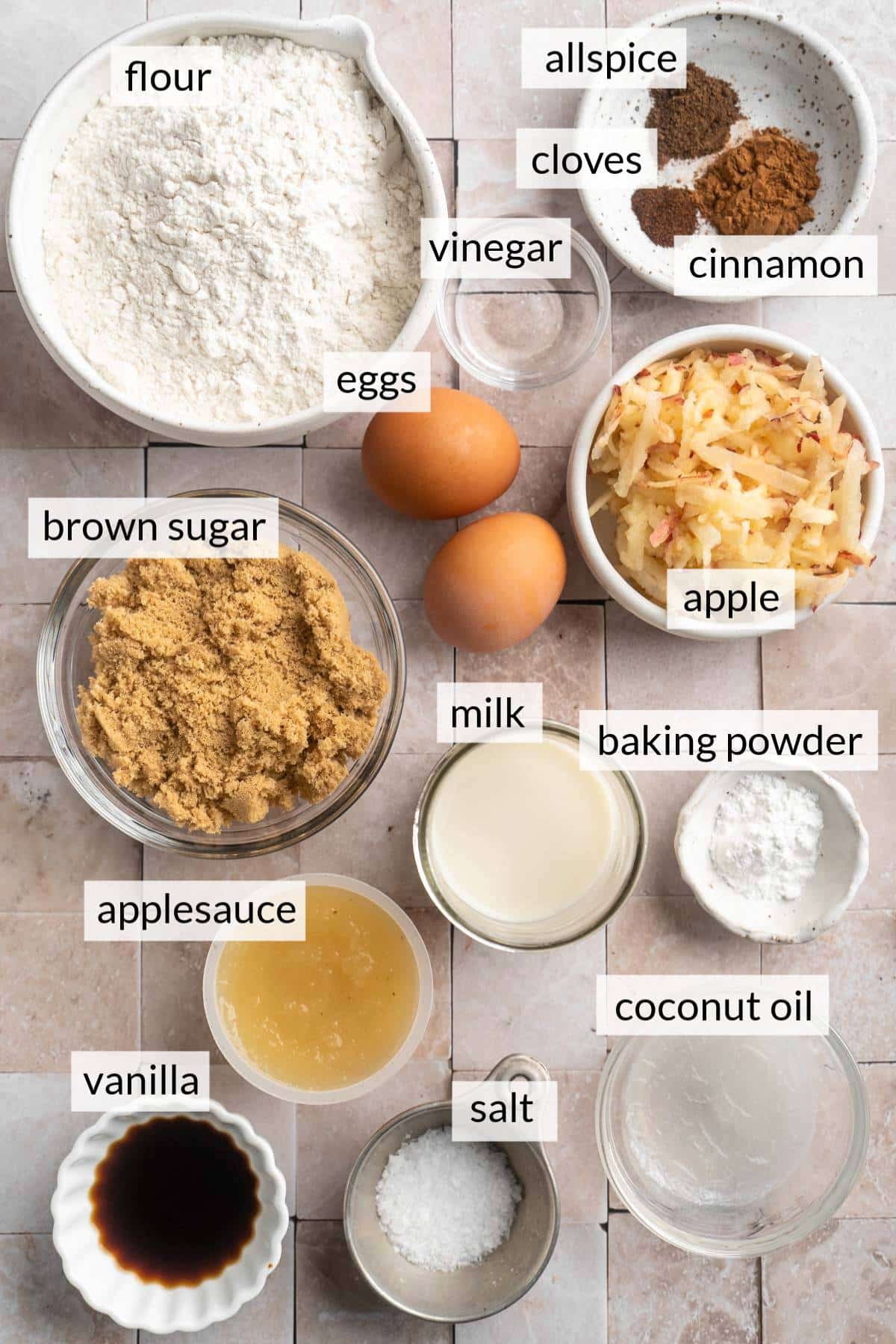 Bowls filled with flour, brown sugar, grated apple, milk and applesauce.