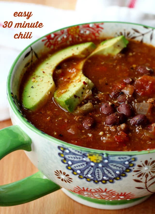 easy 30 minute chili served in a mug and topped with avocado slices